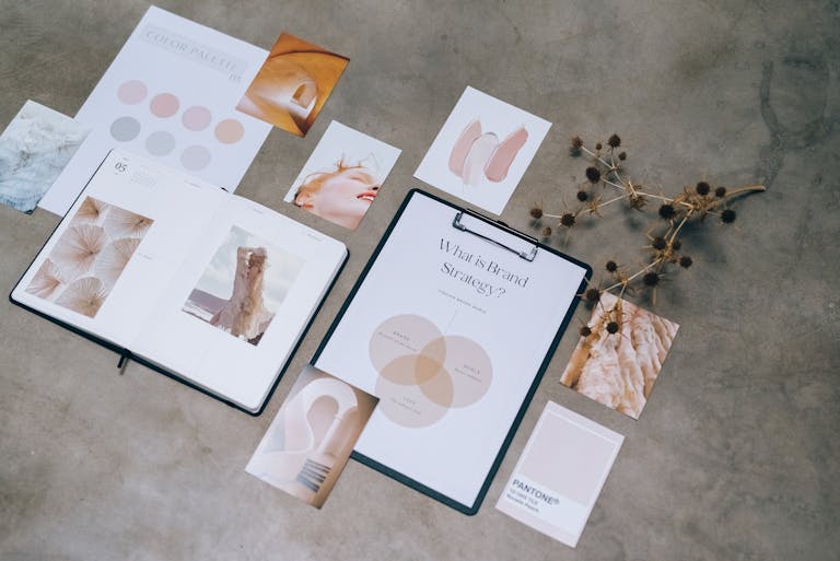 Flat lay of branding strategy materials with moodboard and color palette for creative design.